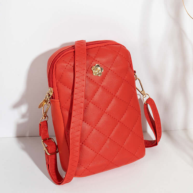 Embroidered Women's Crossbody Bag for Travel and Commuting in vibrant red with gold accents and quilted design.