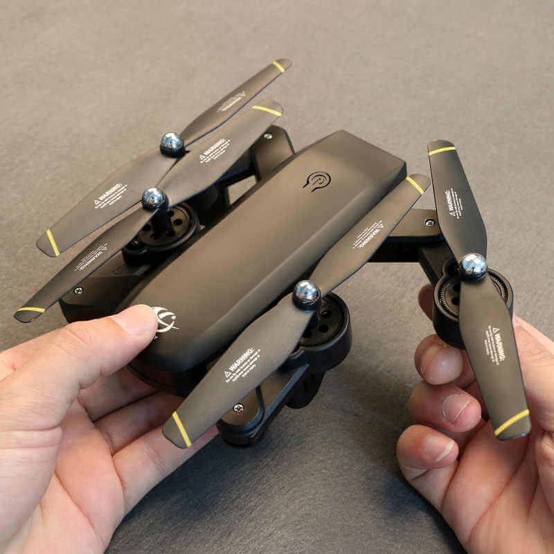 SG700 4K Drone with Dual Cameras and Fly Features in hand, showcasing its compact folding design.