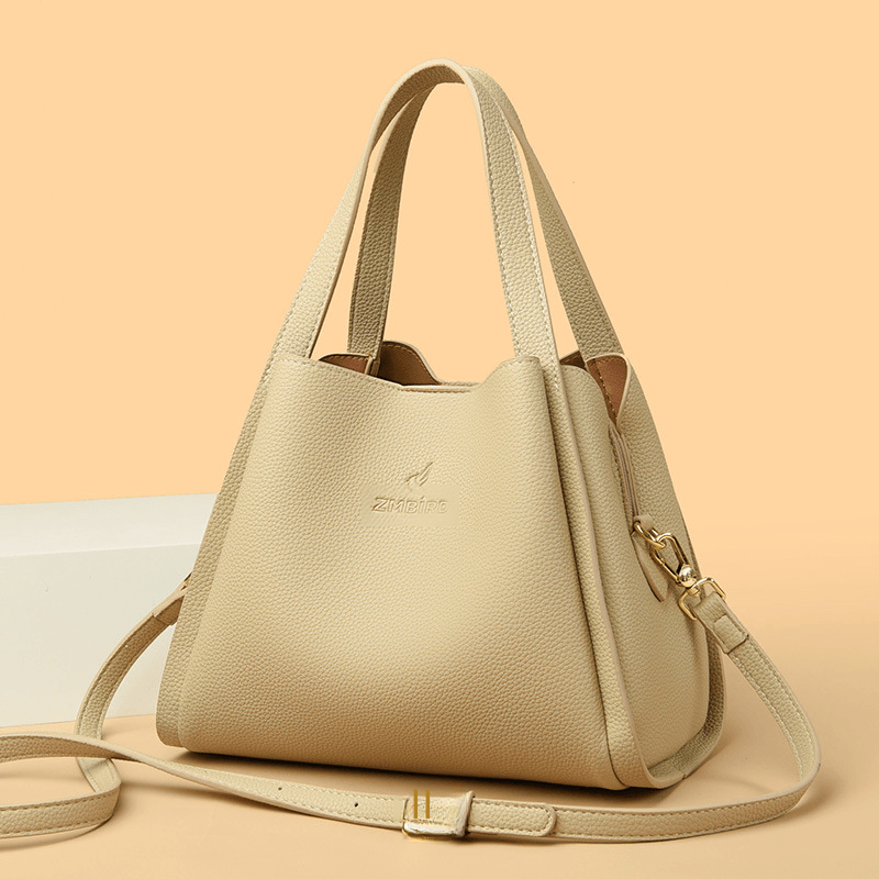 Women's crossbody tote bag in beige PU material with shoulder strap and stylish design.