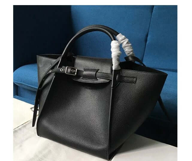 Chic crossbody shoulder bag in elegant black leather with stylish handles and modern design on a blue background.