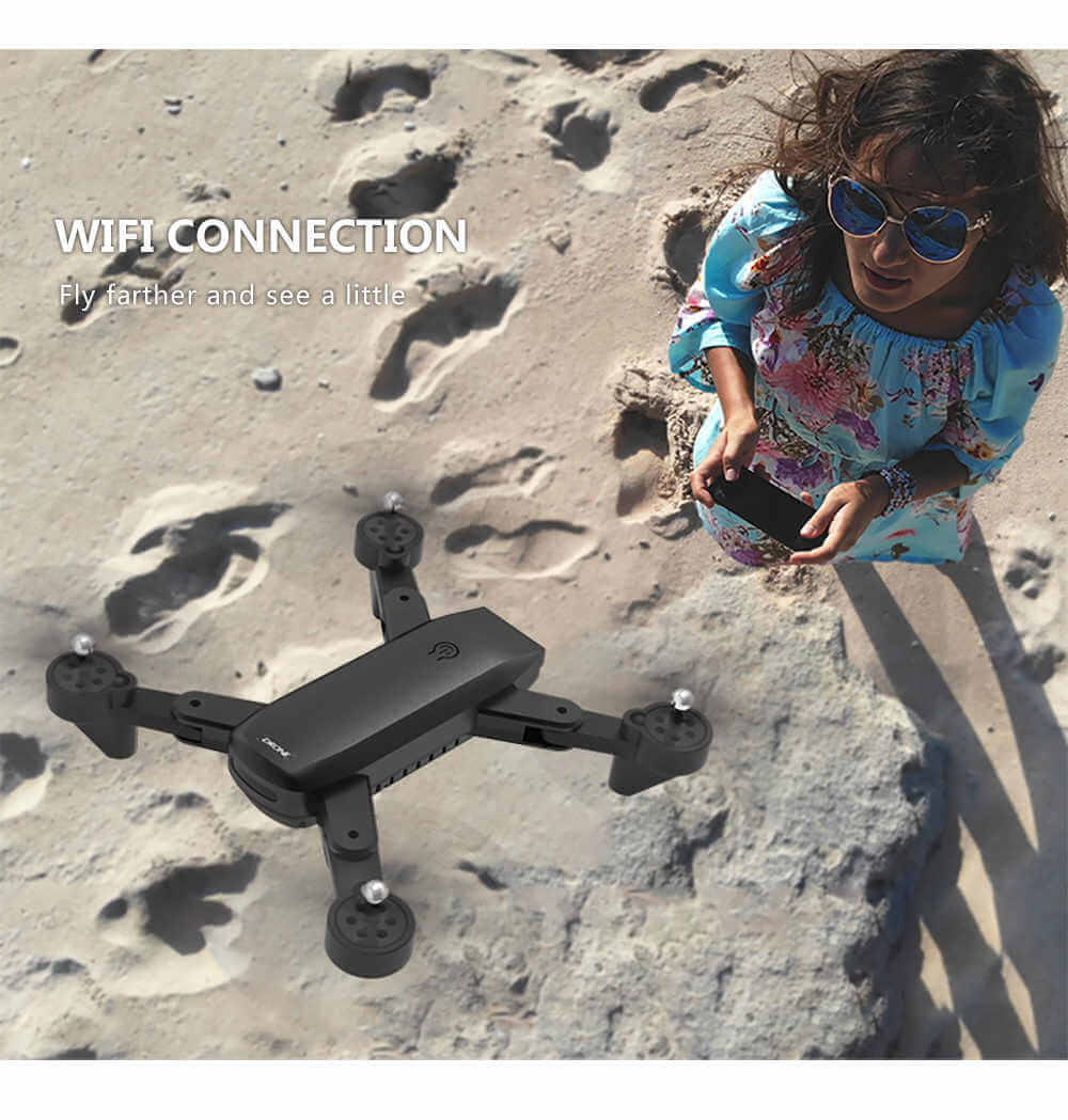 SG700 4K Drone with Dual Cameras and Fly Features flying on the beach with a user taking photos.