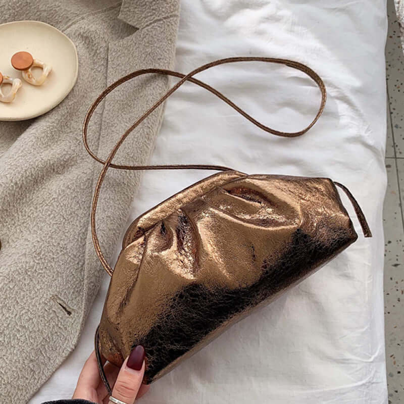 Fashion shoulder dumpling bag in shiny bronze, perfect for daily adventures and stylish looks.