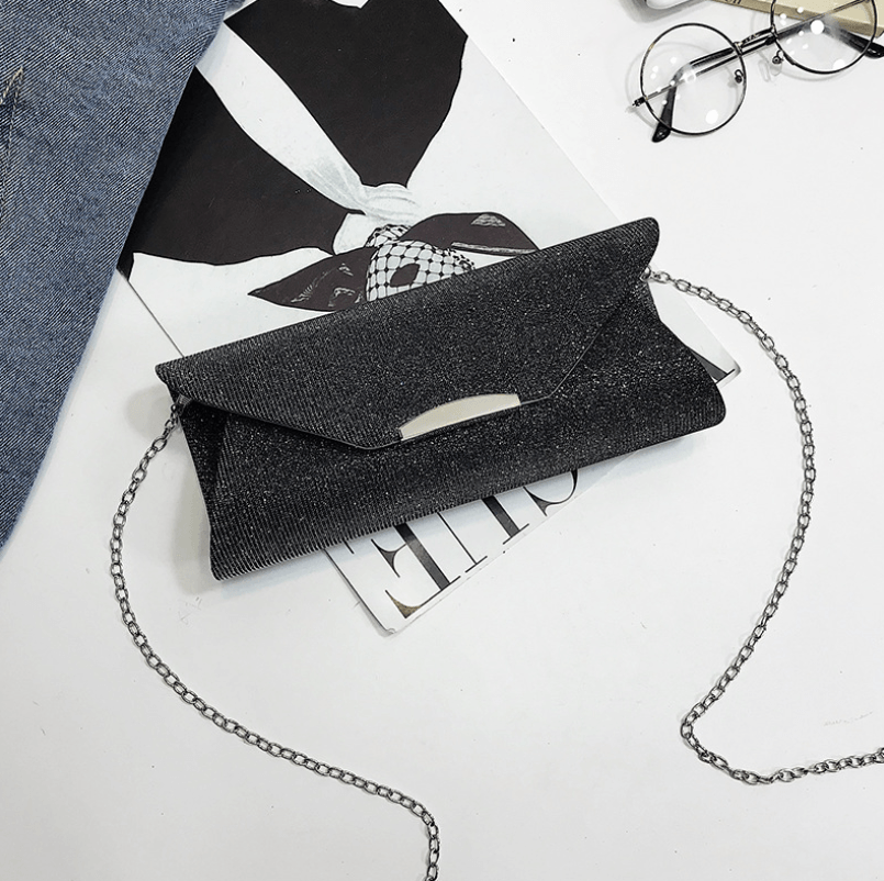 Evening Bag, Clutch, Party Bag, Crossbody Bag on a stylish magazine with glasses, showcasing its elegant design.