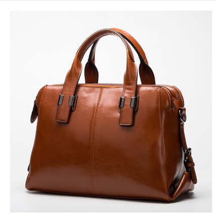 Fashionable Women's Leather Motorcycle Shoulder Bag in a rich brown color, featuring sturdy handles and a sleek design.