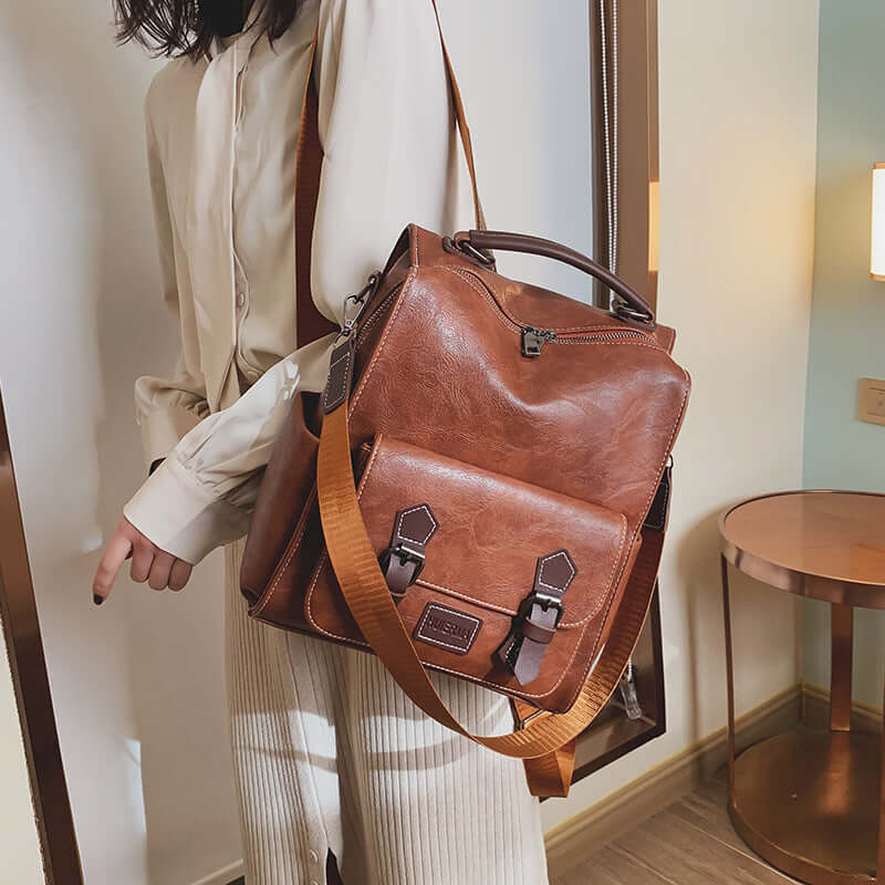 Trendy vintage leather women's travel backpack in brown, stylish and functional for modern travel.