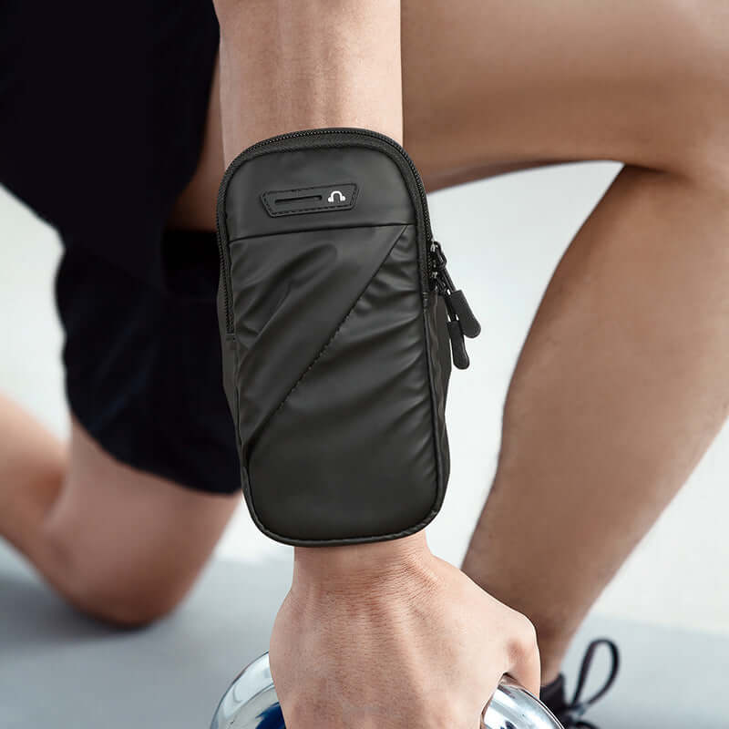 Adjustable Waterproof Arm Bag for Running and Cycling on a person's arm during exercise.