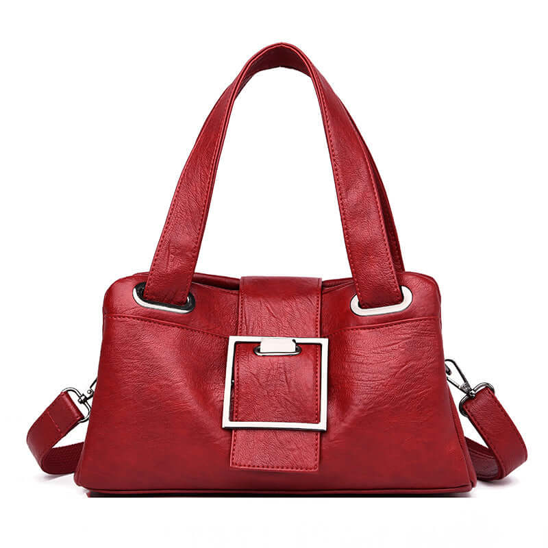 Fashionable red European American leather handbag with stylish buckle design and dual straps.