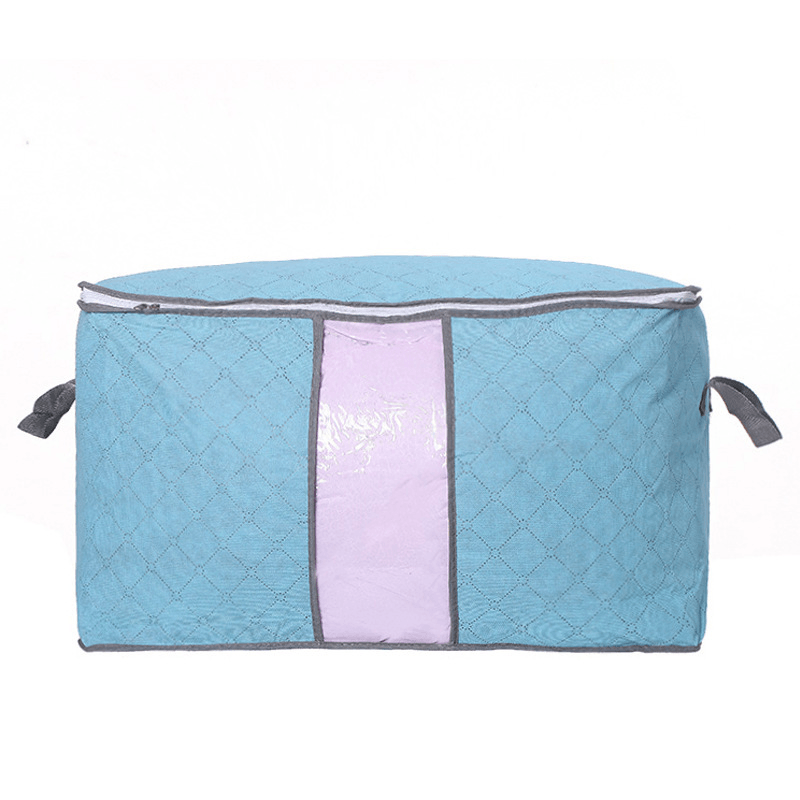 quilt storage bag for moving in blue non-woven fabric with handles and zipper closure.