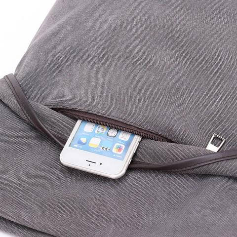 Canvas Women's Bag - Versatile Crossbody Backpack with a front pocket holding a smartphone for easy access.