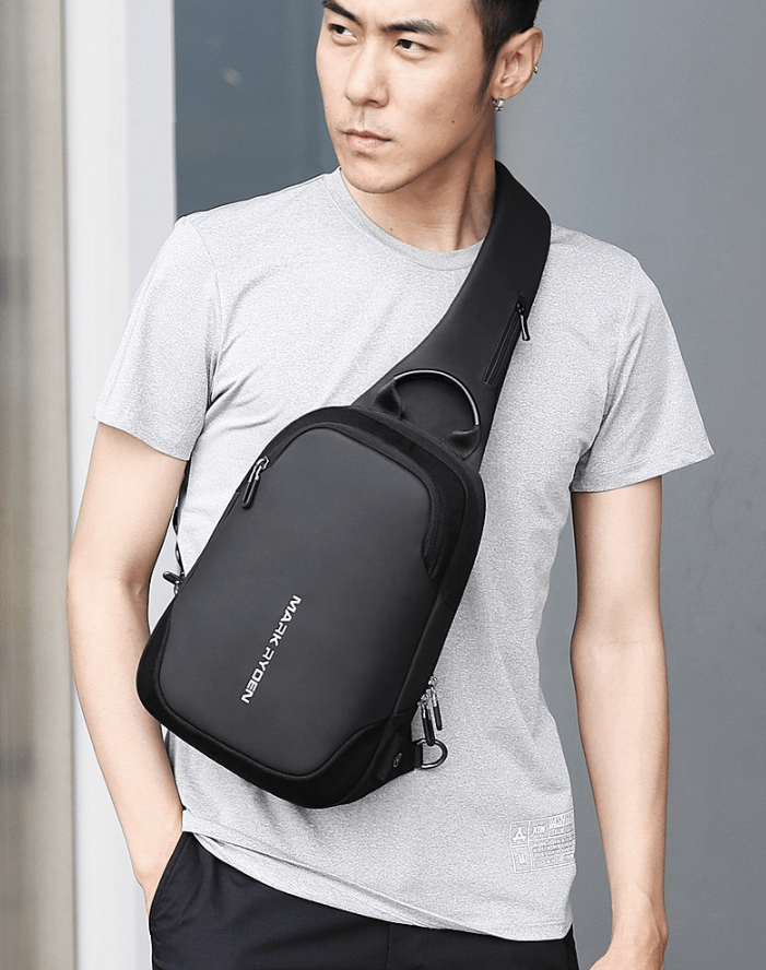 Model showcasing a sleek black business chest bag for professionals, worn crossbody for modern style and functionality.