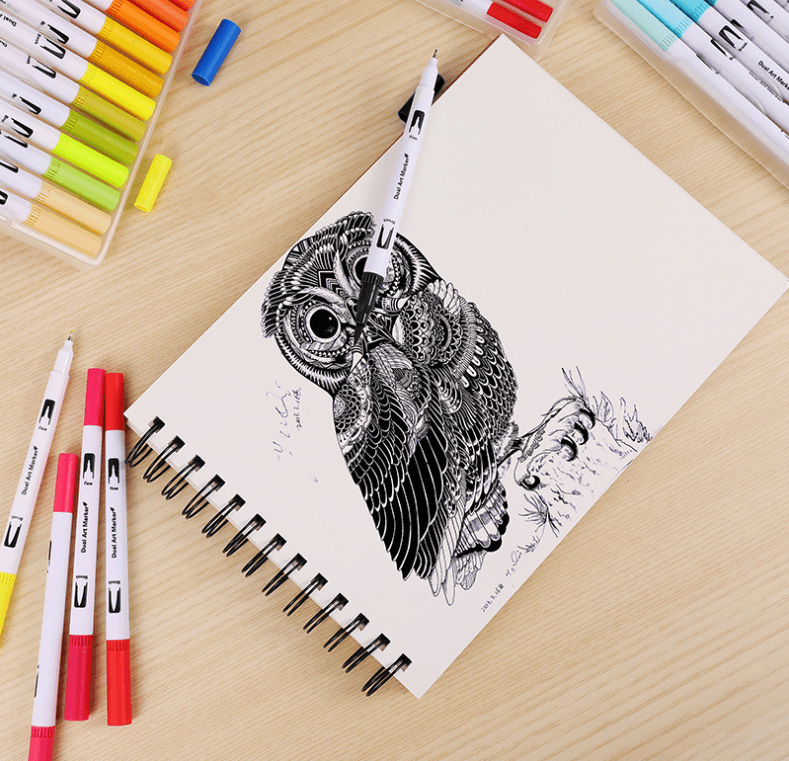 Detailed owl sketch created with Water-Based Color Markers and Drawing Pens, surrounded by vibrant markers.