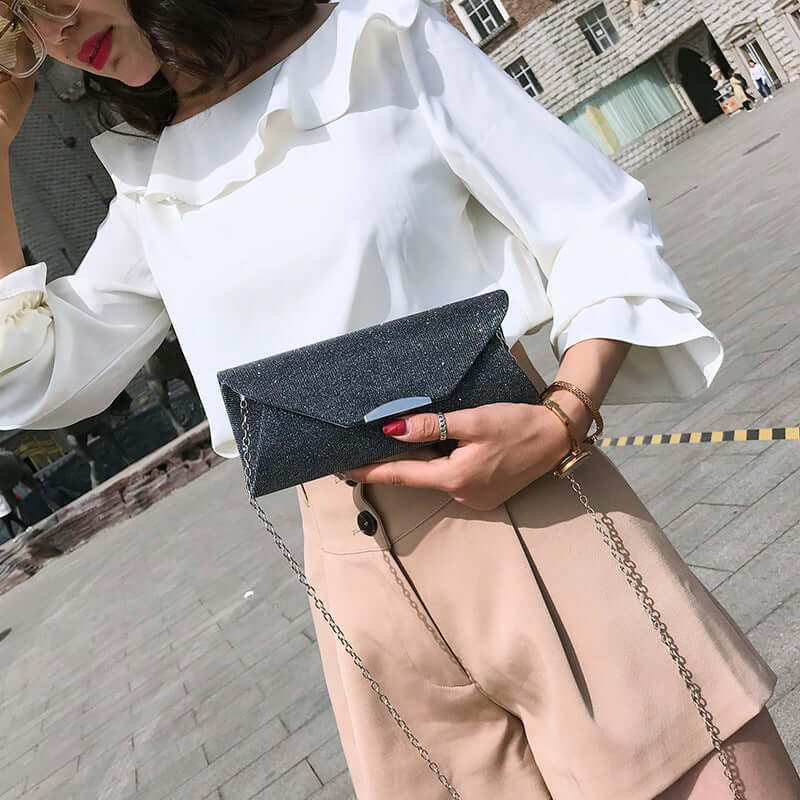 Woman wearing a stylish white top and holding an Evening Bag, Clutch, Party Bag, Crossbody Bag.